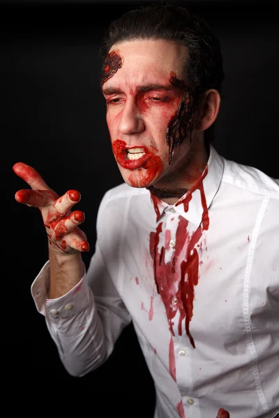 Psychopath licking blood from his fingers — Stock Photo, Image