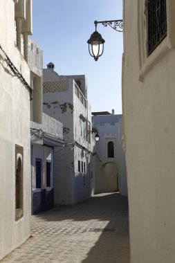 Narrow alley in Assila in the twilight clipart