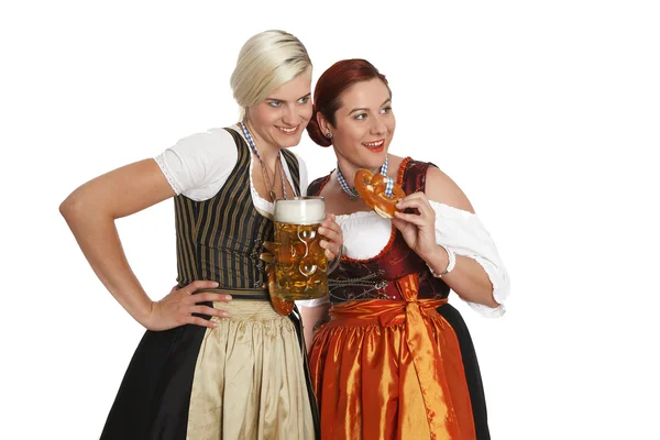Two bavarian girls with beer in traditional costumes — Stock Photo, Image