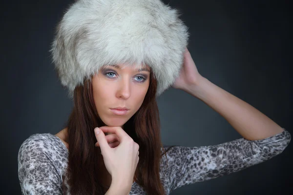 Portrait of a beautiful young model in winter fur hat — Stock Photo, Image