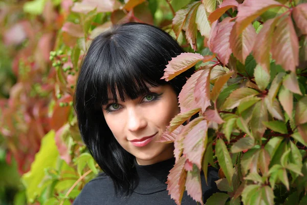 Girl in the leaves of wild grapes — Stock Photo, Image