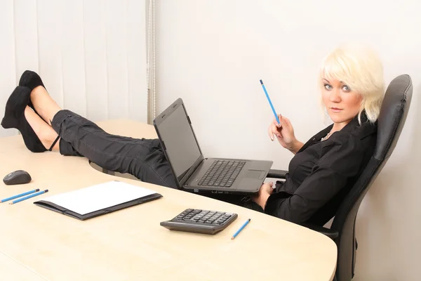 Young pretty business woman with notebook in the office Royalty Free Stock Photos
