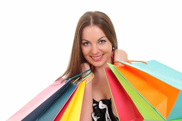 Retrato de jovem com sacos de compras contra fundo branco — Fotografia de Stock