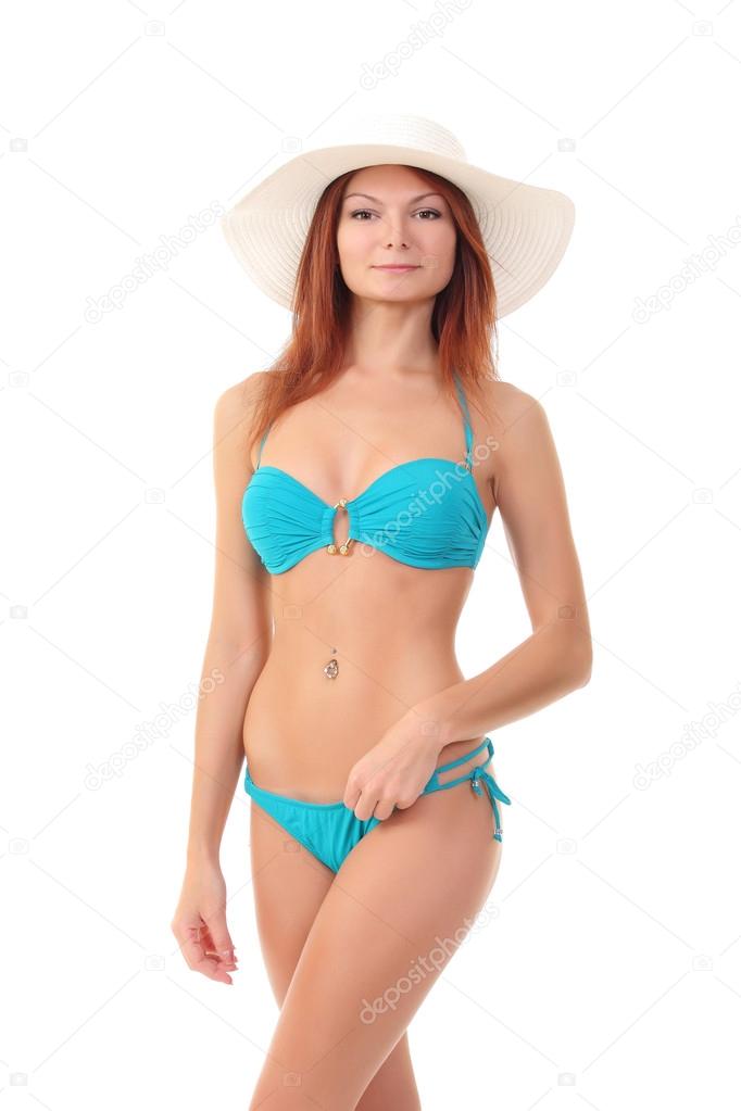 Red-haired beauty in a bikini and beach hat Stock Photo by