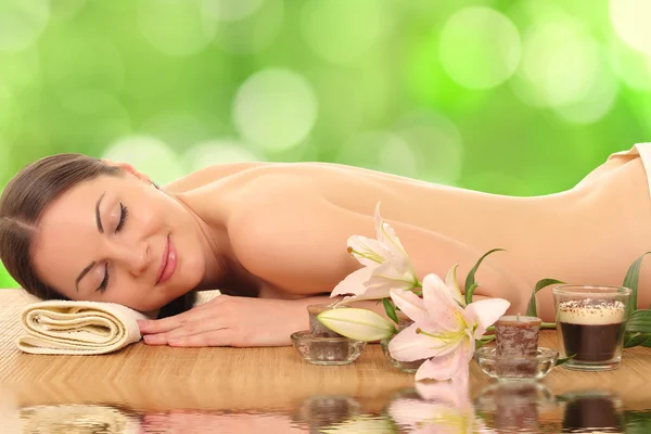 Woman relaxing in spa, with reflection on the water — Stock Photo, Image