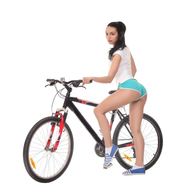 Chica sexy con una bicicleta sobre un fondo blanco — Foto de Stock