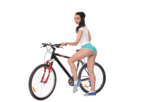 Beyaz zemin üzerinde bir bisiklet ile seksi kız — Stok fotoğraf