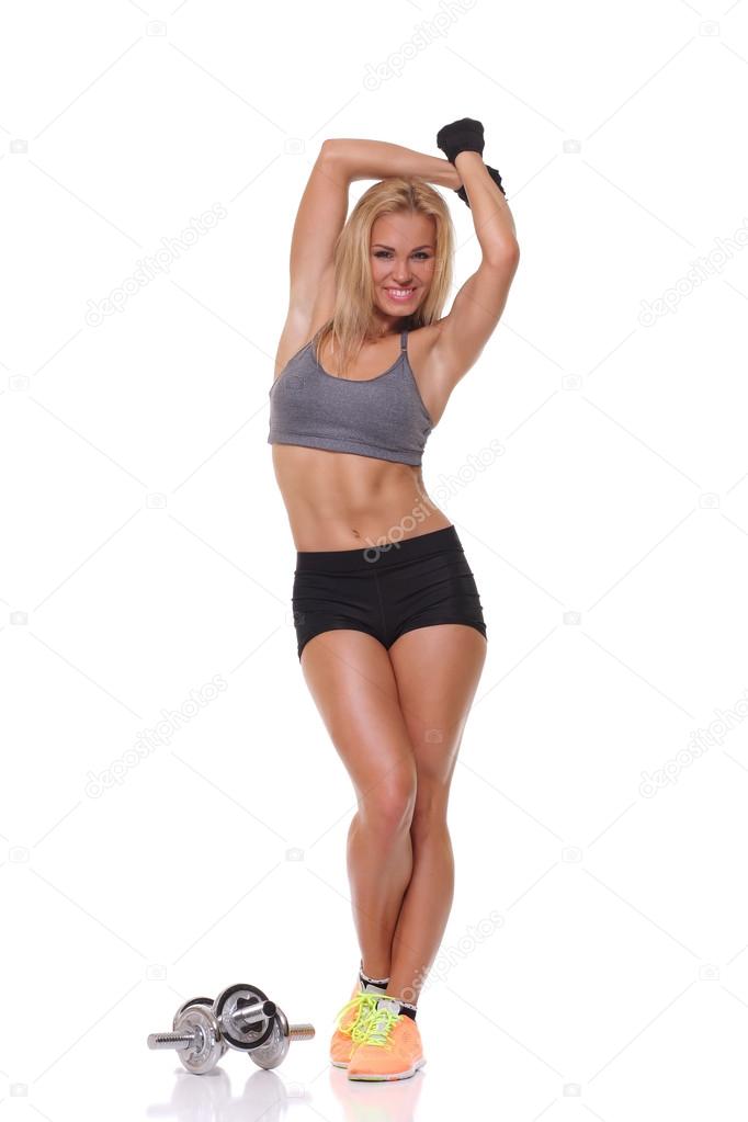 athletic young woman doing a fitness workout with dumbbells 