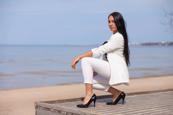 stock image Beautiful brunette in full length against the sea