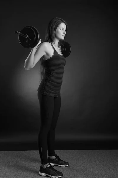 Young Strong Woman Raises Barbell Black Background — 图库照片