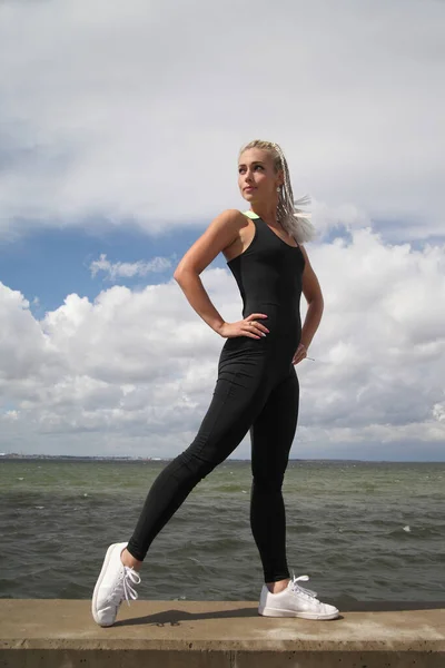 young beauty sports woman in black sportswear