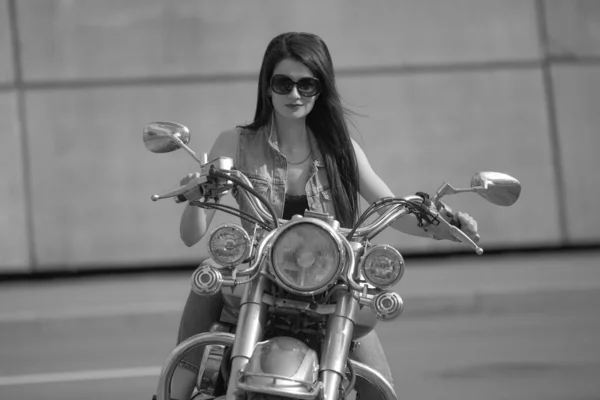 Portrait of charming young woman on motorcycle