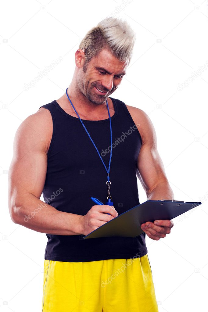 Personal Trainer, with a pad in his hand, isolated in white