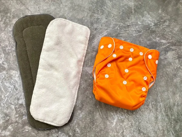 Reusable Orange Baby Diaper Two Inserts 图库照片