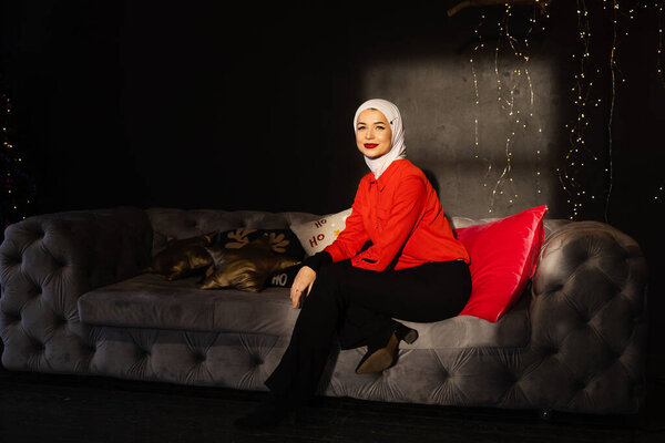Muslim woman near christmas lights and decoration in studio. Professional muslim model posing at the new year eve. — Stock Image Muslim Woman Christmas Lights Decoration Studio Professional Muslim Model Posing Royalty Free Stock Photos