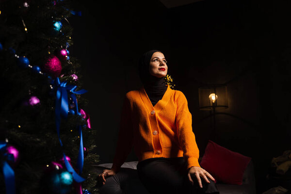 Muslim woman in black hijab near new year tree waiting for celebration of Christmas. Islam religion — Stock Image Muslim Woman Black Hijab New Year Tree Waiting Celebration Christmas Royalty Free Stock Images