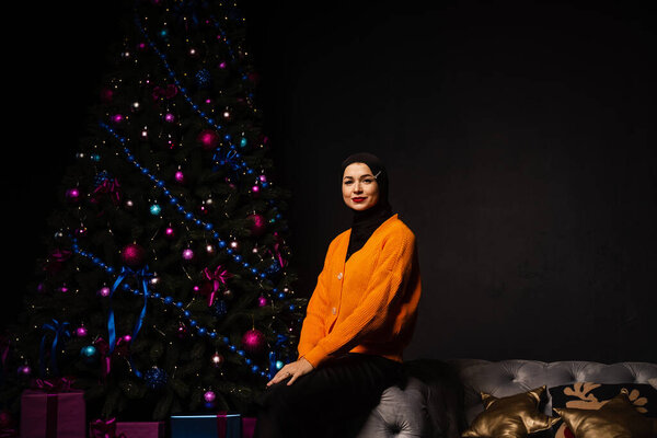 Muslim Christmas celebration. Model weared black hijab is prepearing for new year celebration. Islam religion — Stock Image Muslim Christmas Celebration Model Weared Black Hijab Prepearing New Year Stock Picture