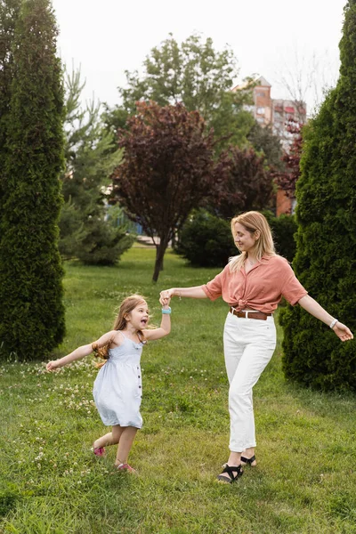 Mom and daughter having fun together. Happy family lifestyle. Daughter jumping, smiling and laughing. Love in family