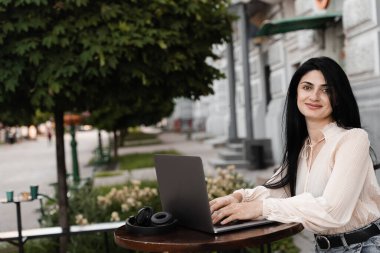 Elinde vitiligo pigmentasyonu olan çekici bir kadın. Bilgisayarda çalışan ve dışarıdaki kafede arkadaşlarıyla sohbet eden bir kız. Deri hastalıklı yaşam tarzı.