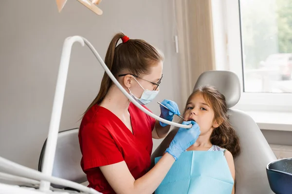 Dental drill. Child dentist drilling teeth of kid girl in dentistry clinic. Dental filling for child patient