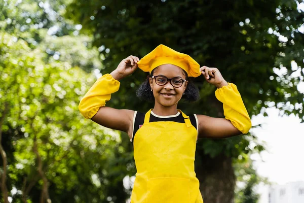 Black African Child Cook Girl Chefs Hat Yellow Apron Uniform — kuvapankkivalokuva