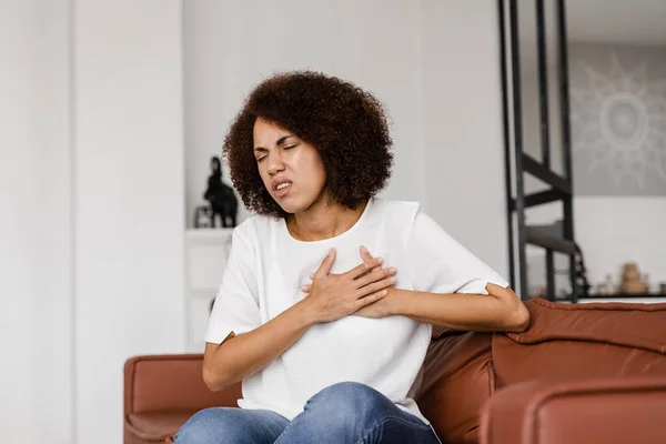 Heart attack disease of african american woman. Symptoms of angina pectoris. Attractive sick black girl with heart ilness infarkt