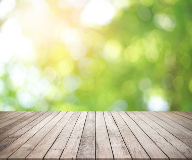 wood table and blurred nature background.