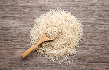 raw rice on wood table background. healthy food