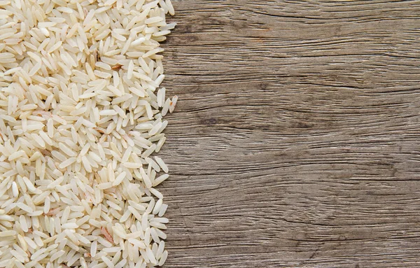 raw rice on wood table background. healthy food