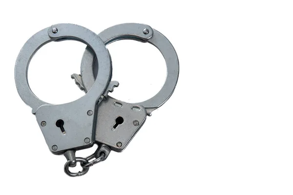 Metal handcuffs on a white isolated background, copy space — Stock Photo, Image