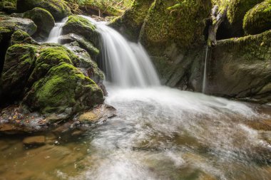Hoar Oak Nehri 'nin üzerinde Exmoor Ulusal Parkı' ndaki Watersmeet 'te akan şelalenin uzun pozu.