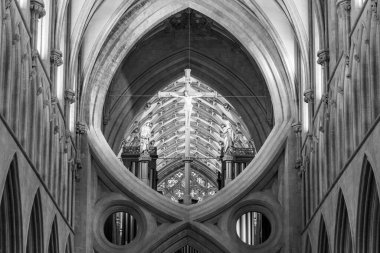 Wells.Somerset.United Kingdom.December 30th 2021.A statue of Jesus Christ on a cross is mounted abovf the scissor arches  inside Wells cathedral in Somerset