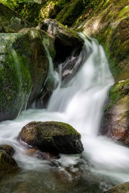 Hoar Oak Nehri 'nin üzerinde Exmoor Ulusal Parkı' ndaki Watersmeet 'te akan şelalenin uzun pozu.