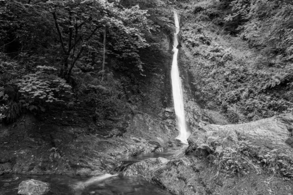 Long exposure of the White Lady waterfall on the river Lyd at Lyford Gorge in Devon