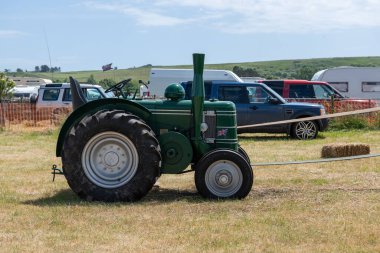 West Bay.Dorset.United Kingdom.June 12th 2022.A restored vintage Field Marshall tractor is being displayed at the West Bay vintage rally