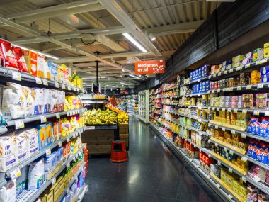 Orebro, Sweden - December 15, 2021: Horizontal Night View of ICA Nara Grocery Interior in Orebro City.