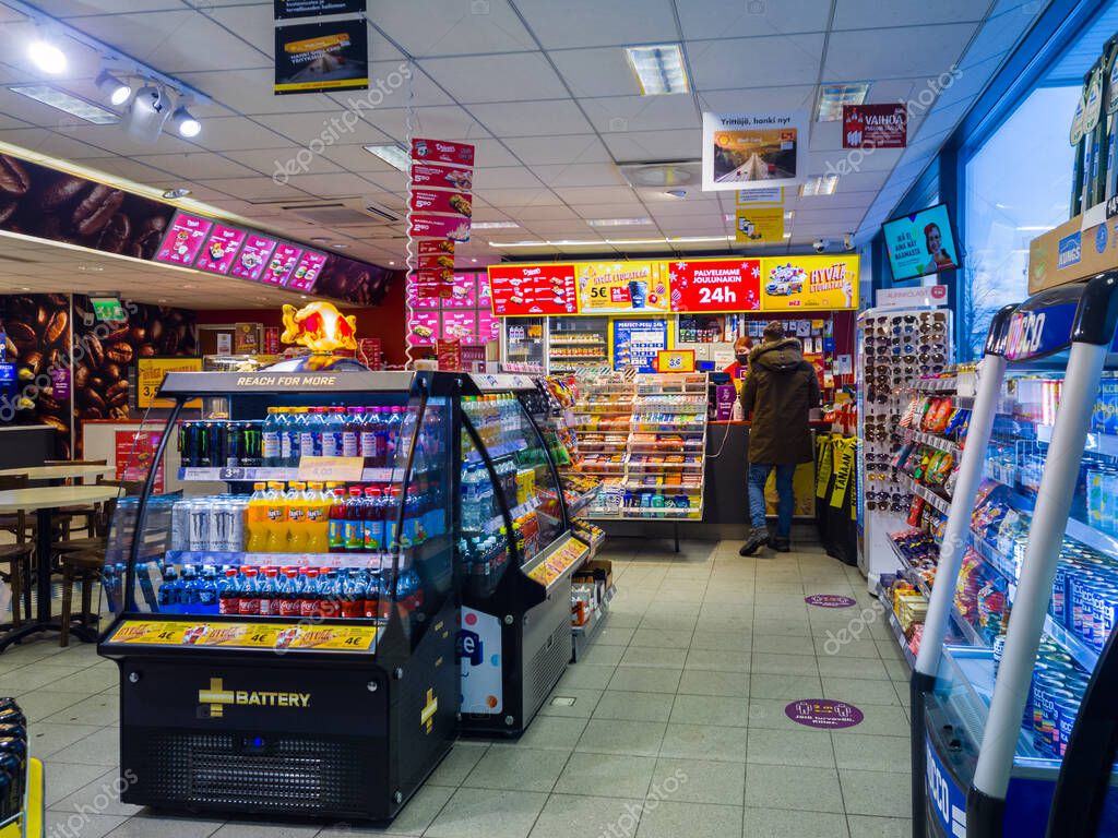 Turku, Finland - December 24, 2021: Horizontal View of Shell Gas Station Convenience Store Cashier and Customer.