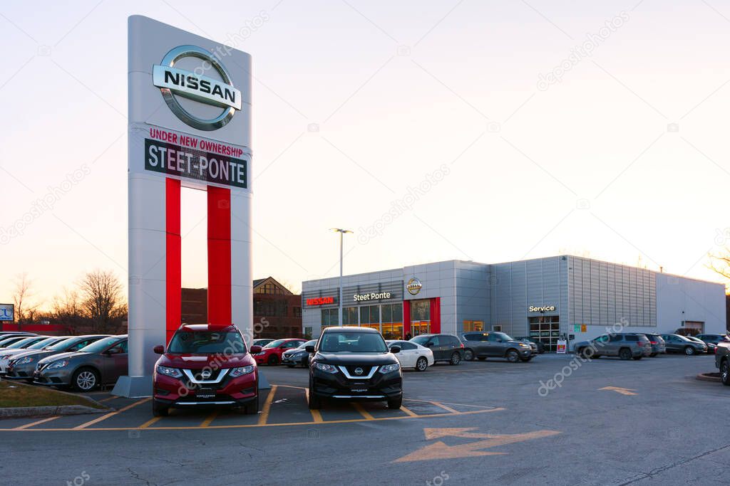 New Hartford, New York - Mar 29, 2022: Landscape Ultra Wide View of Nissan Steet Ponte Dealership Building Exterior with Brand New Cars Parked in Front.