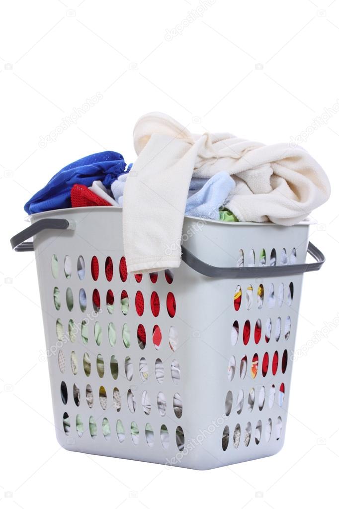 Baby clothes in a laundry basket , Isolated background