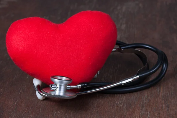 Medical, Red heart with stethoscope on wood table — Stock Photo, Image