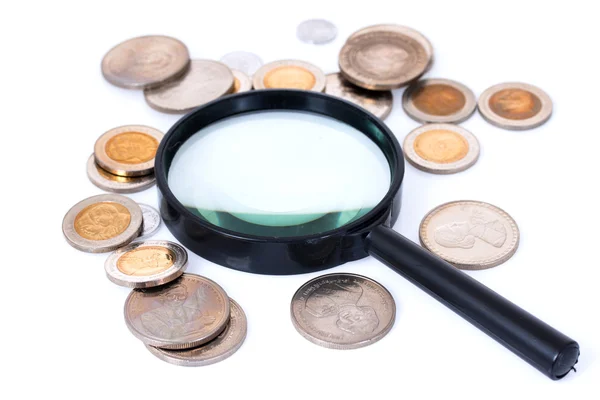 Magnifying glass with coins — Stock Photo, Image