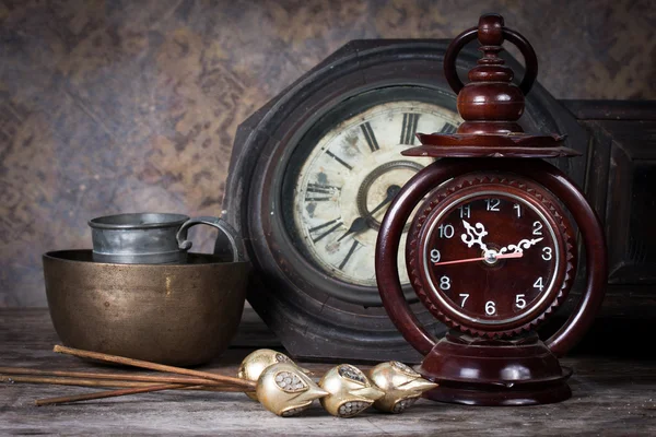 Group of objects on wood table. old clock, antique wooden clock — Stock Photo, Image