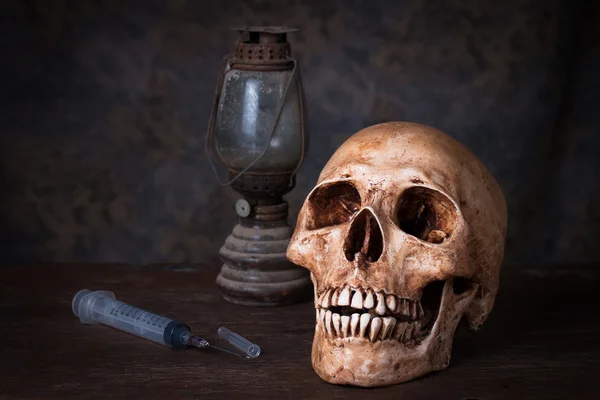 Human skull and syringe — ストック写真