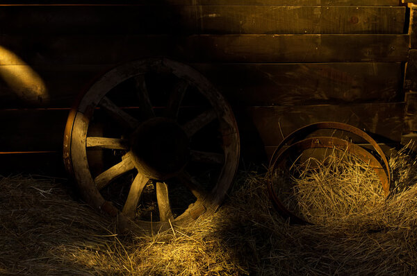 The old wooden wheel on a hay