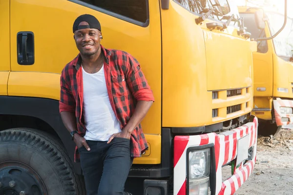 truck driver smiling confident in insurance cargo lorry In long transportation and delivery business. young African-American man training driving commercial driver license at truck driving school.