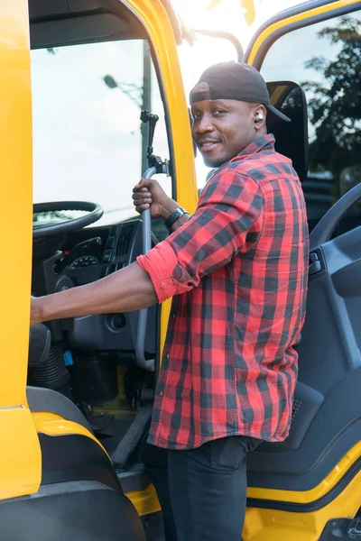 truck driver smiling confident in insurance cargo lorry In long transportation and delivery business. young African-American man training driving commercial driver license at truck driving school.