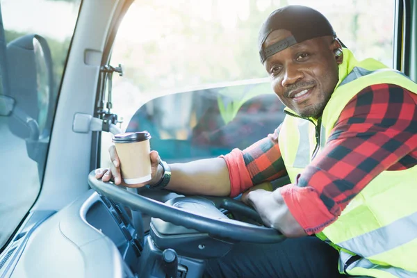 truck driver smiling confident in insurance cargo lorry In long transportation and delivery business. young African-American man training driving commercial driver license at truck driving school.