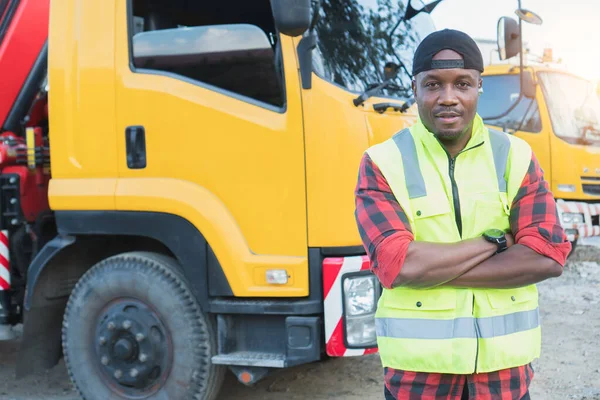 truck driver smiling confident in insurance cargo lorry In long transportation and delivery business. young African-American man training driving commercial driver license at truck driving school.