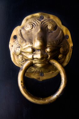 Eski paslı geçit üzerinde siyah kapı.