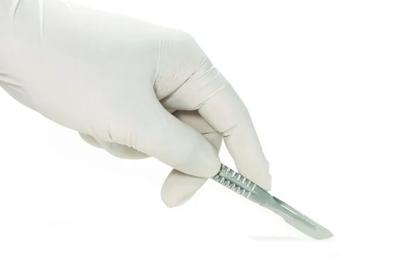 Scalpel in a hand with rubber glove Stock Photo